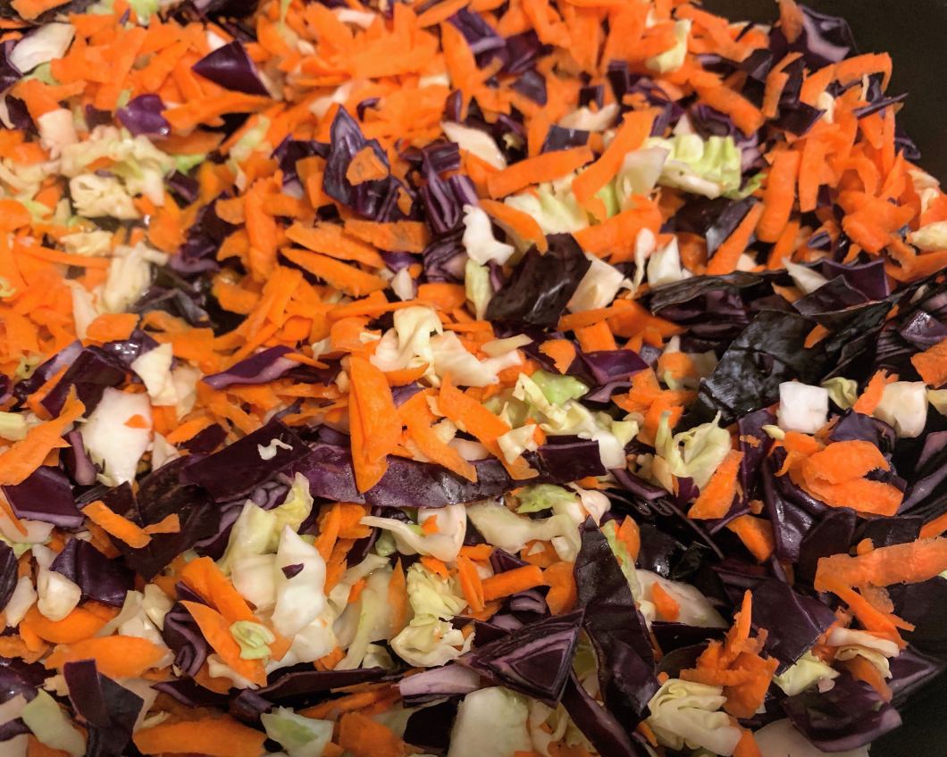 shredded red cabbage, green cabbage and carrots for vegan egg rolls